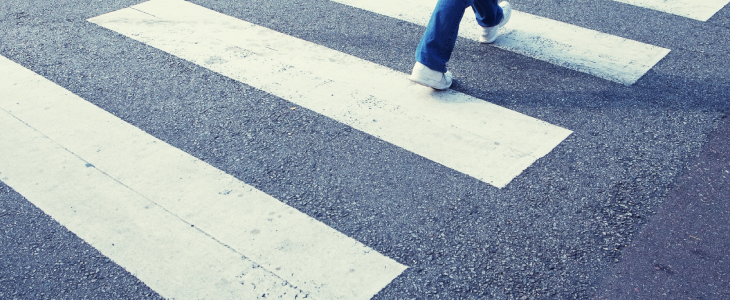 Pedestrian walking in the crosswalk in NYC